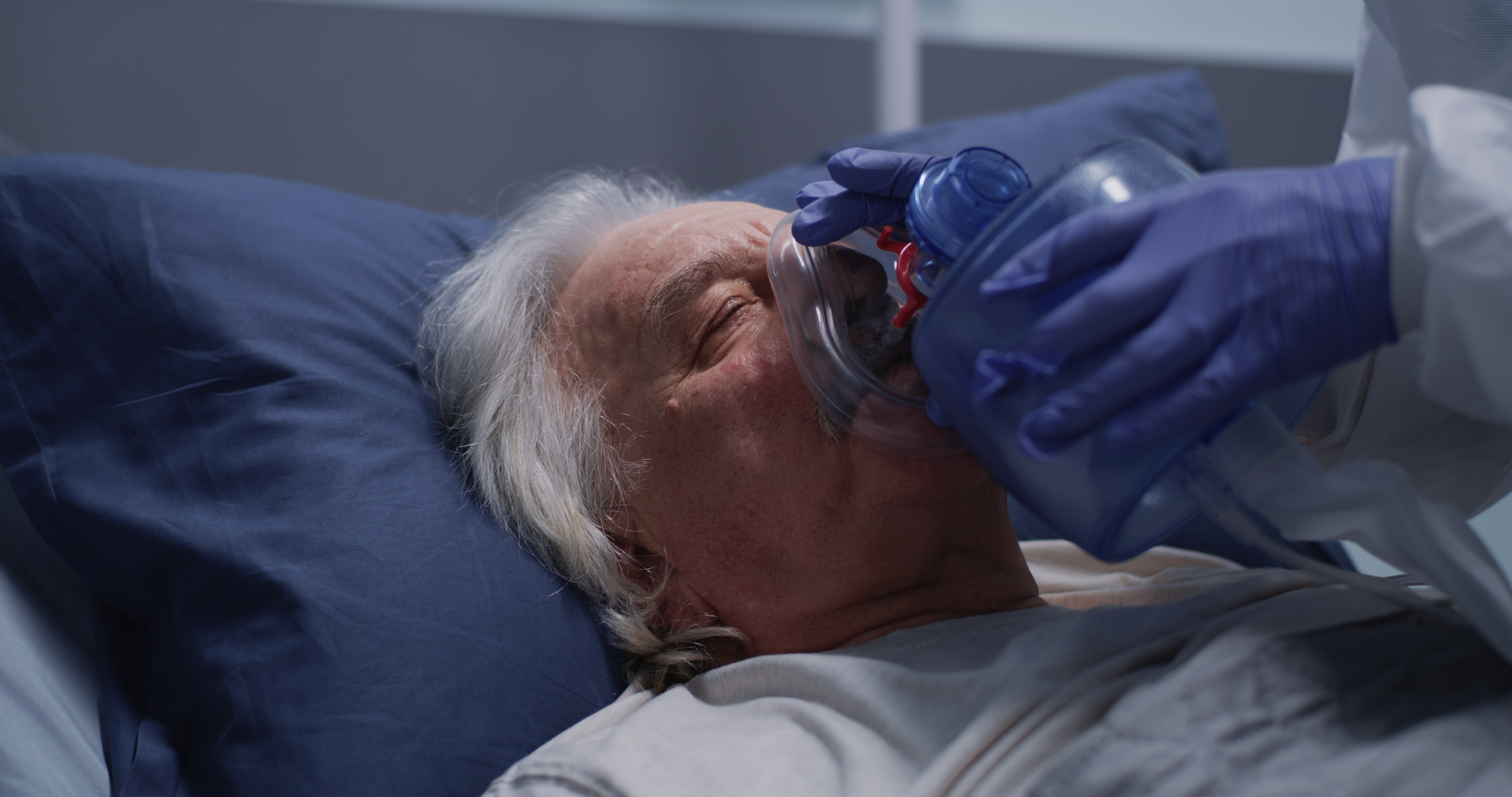 crop medical practitioner in latex gloves using oxygen pump on senior male patient in SBI 350756645